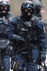 Armed police officers walk in Tottenham Court Road in central London